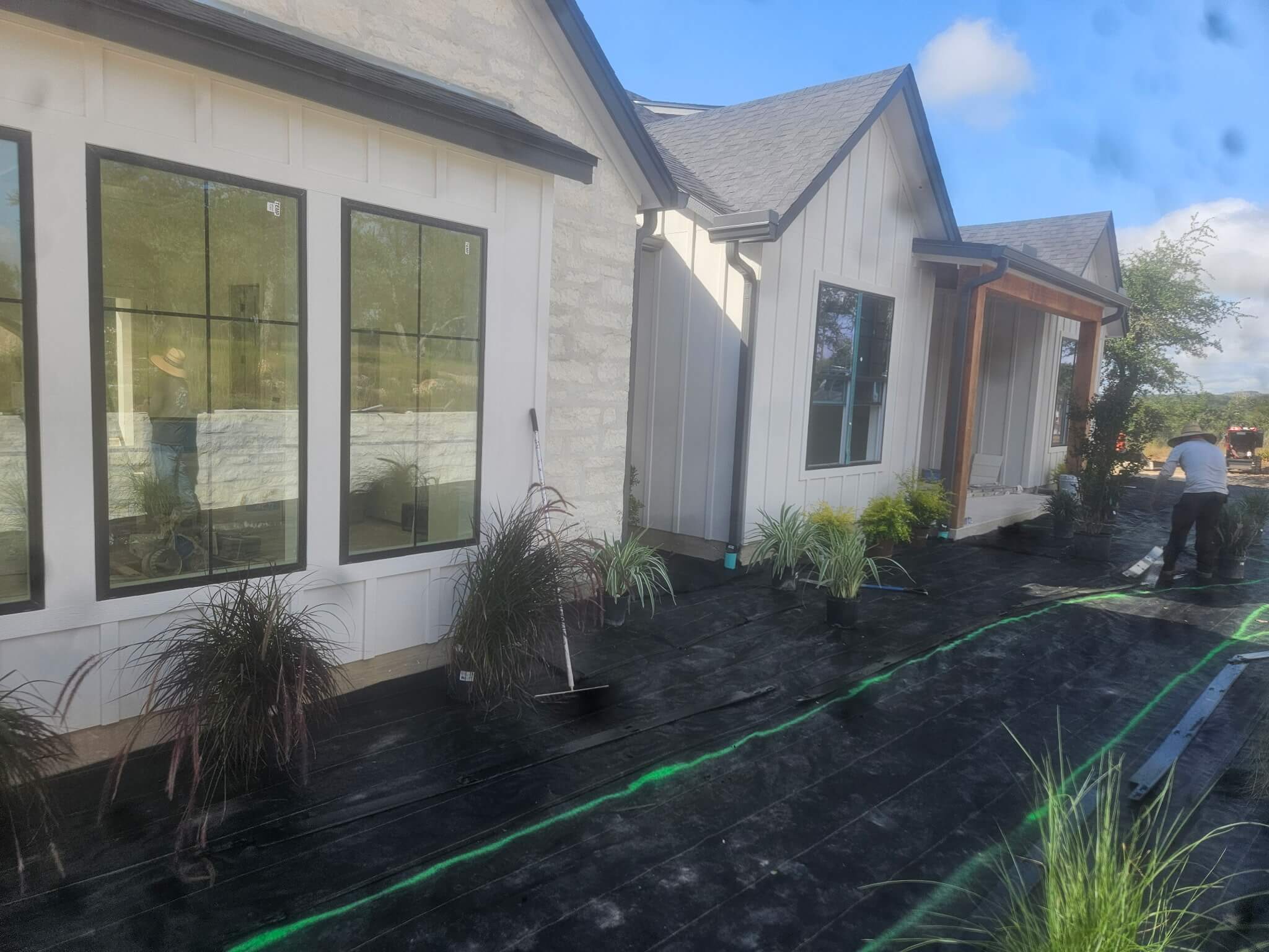 Landscape bed with weed barrier fabric installation